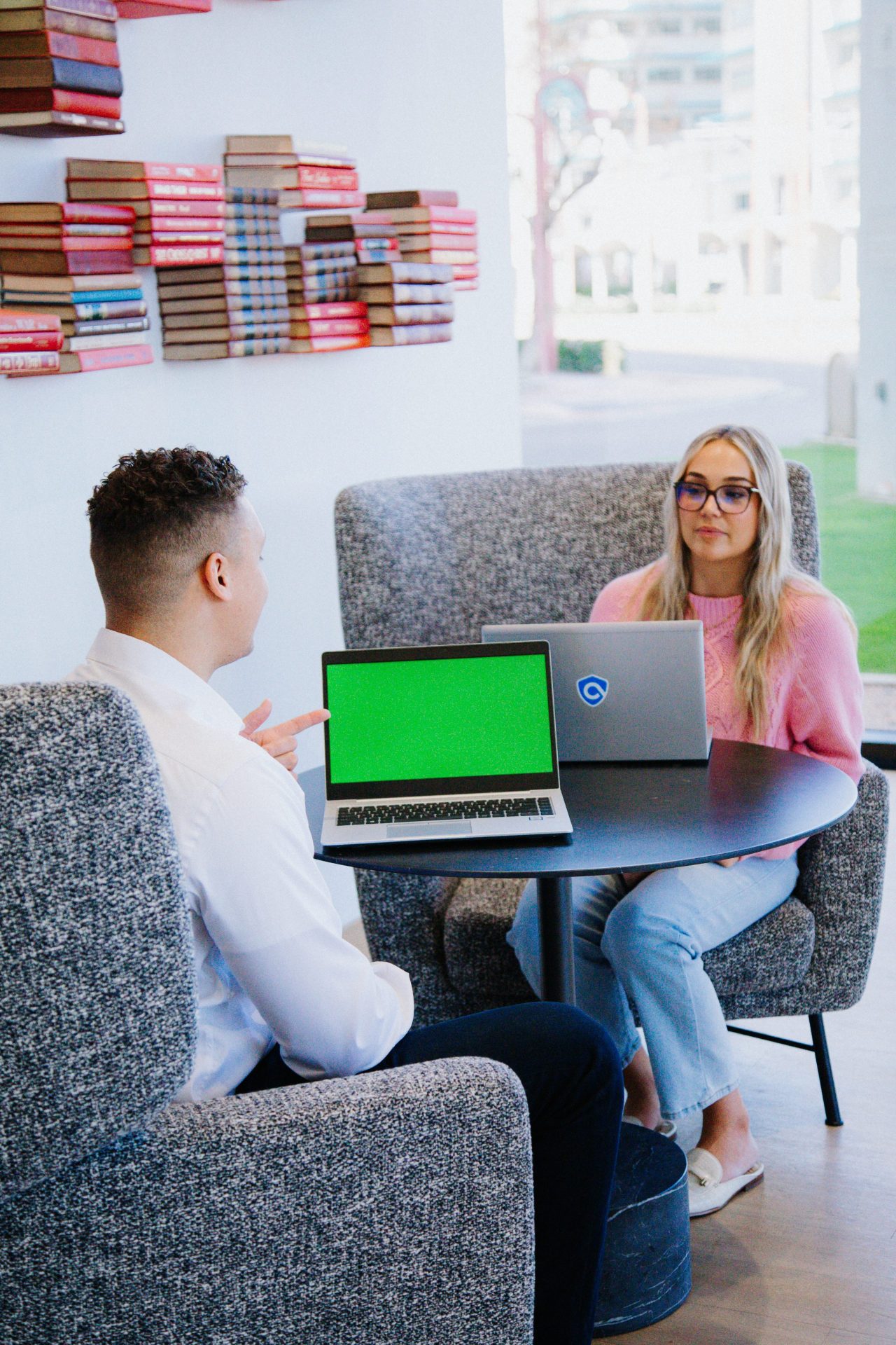 People at a table with their ArmorPoint laptops in an office, working in co-working space